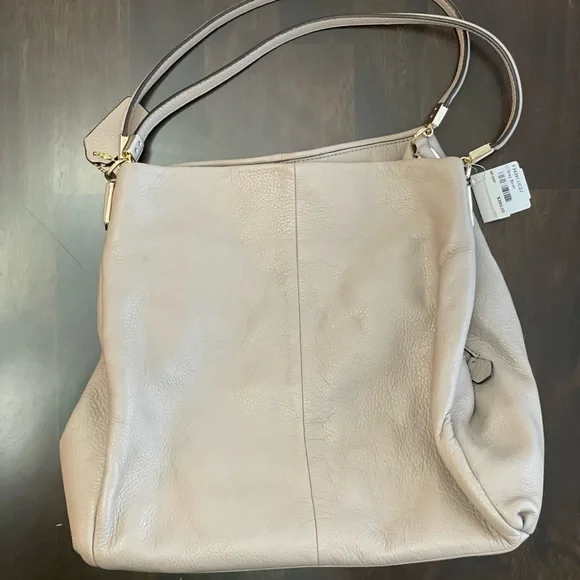 Coach cream colored purse with lavender interior. Never used